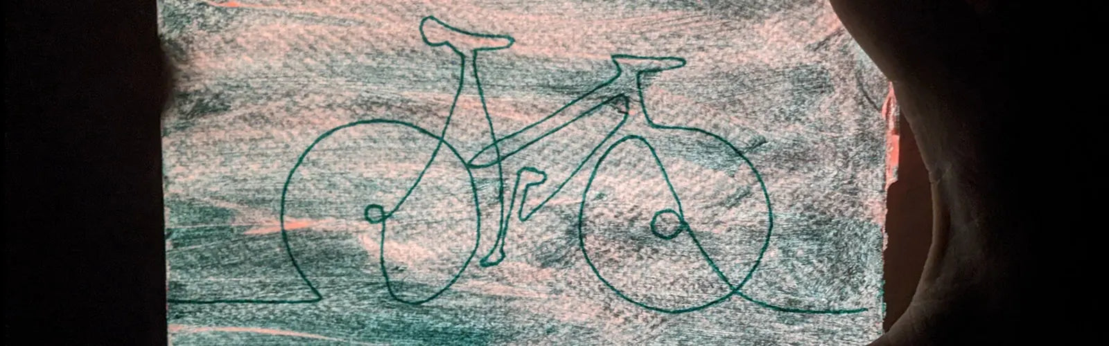 An embroidered stylized bike on fabric