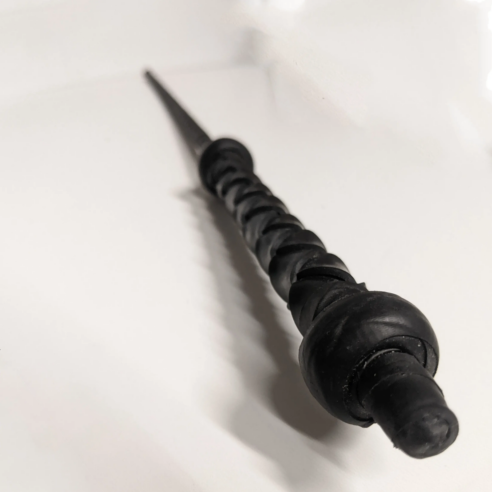 A black cane with a braided handle