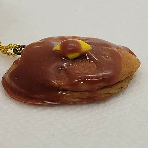 A two pancake stack charm with syrup and butter, shown from the side