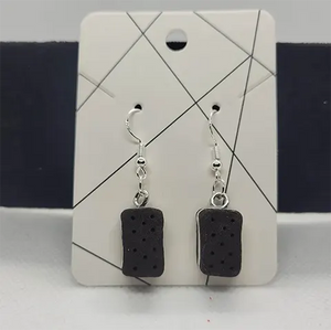 A pair of black rectangular ice cream sandwich earrings 